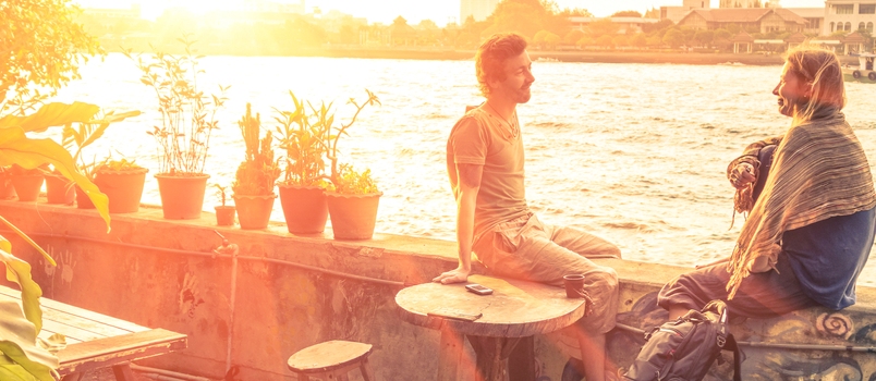 Happy Couple Conversation Together On The Wall Outside Of The Cafe Or Resturant