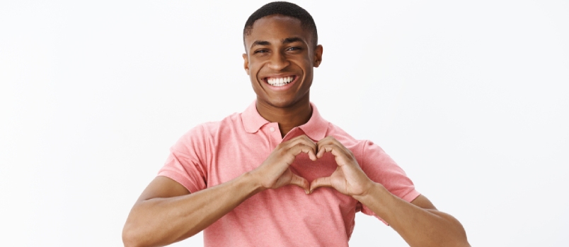 african american young male sharing love and tender feelings showing heart gesture and smiling broadly confessing in sympathy