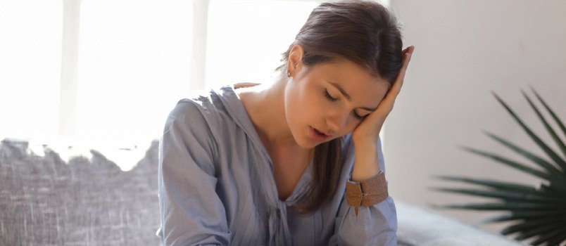 sad woman with her head in her hands