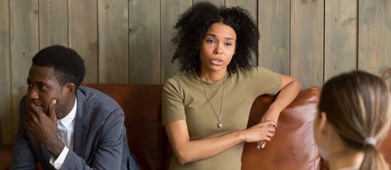 Frustrated couple talking to psychologist