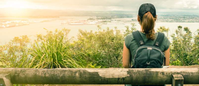 woman sitting on the bench looking at the vastness