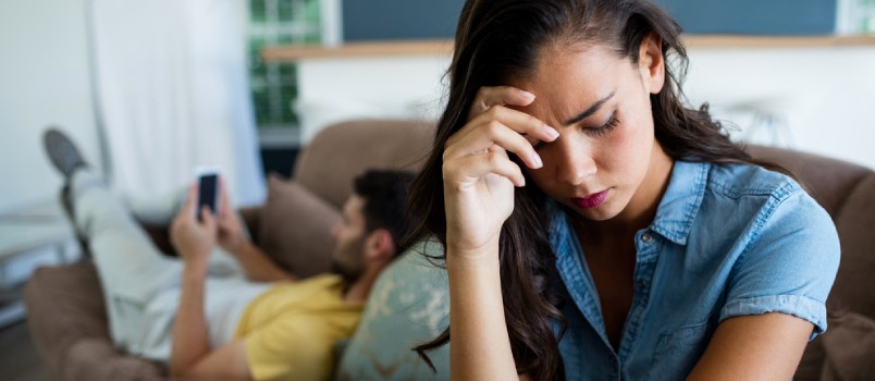 Woman upset with man using his phone
