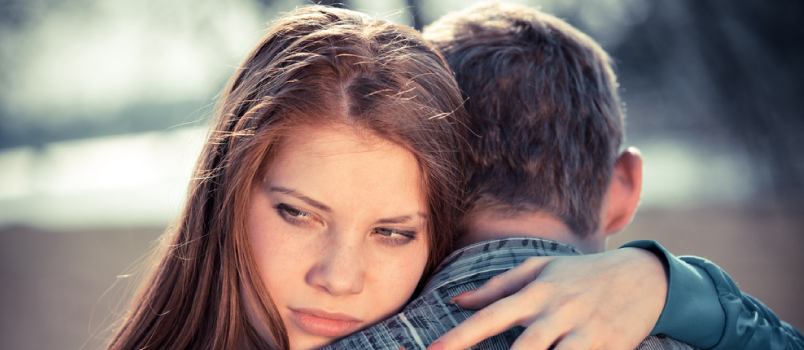 Anxious woman hugging her partner