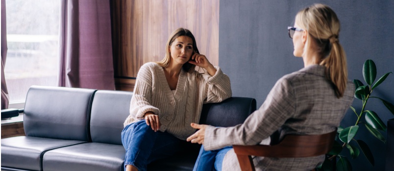 Young woman consulting psychologist