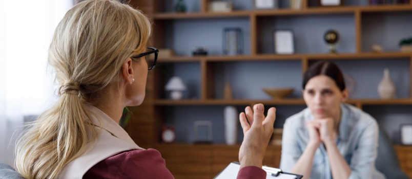 Young woman consulting psychologist
