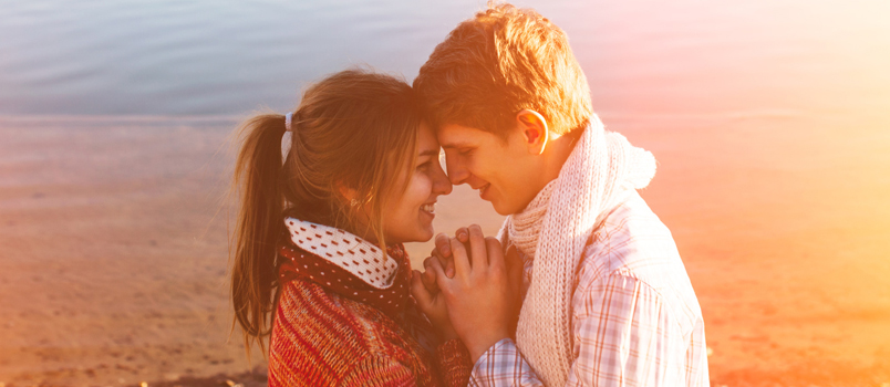 Couple standing face to face holding hands Couple standing face to face holding hands