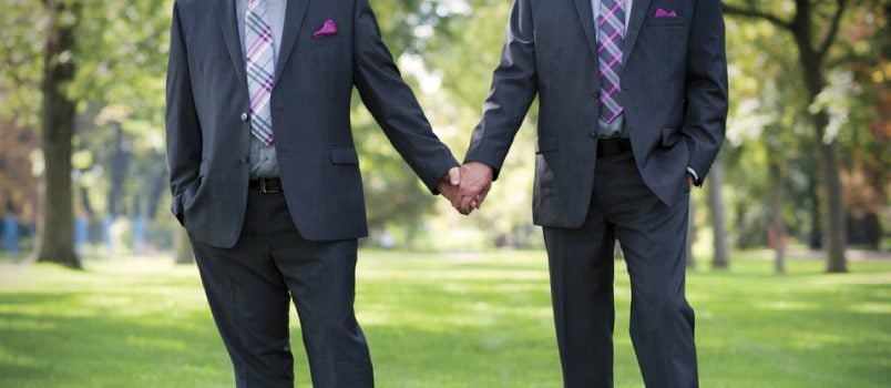 Newly married gay couple holding hands