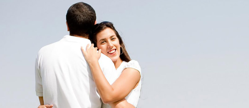 White couple standing hugging each other