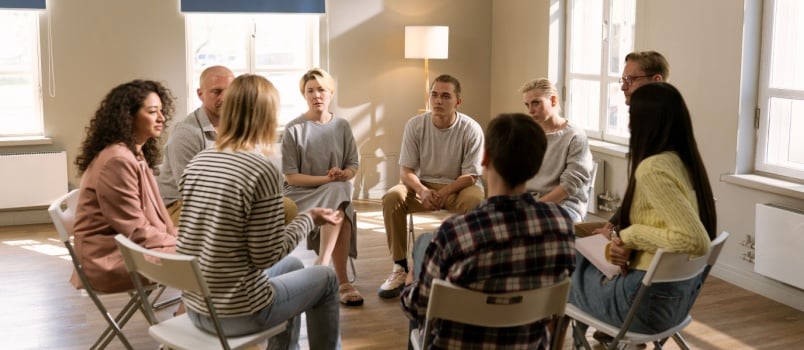 Diverse group people sat on chair