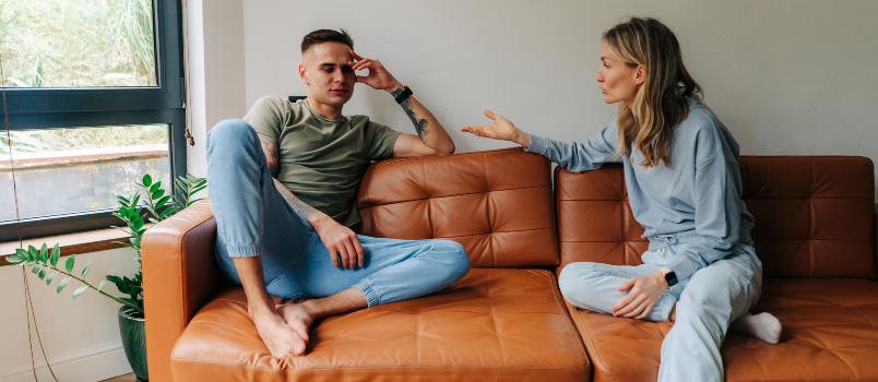 Man and Woman on Couch in Living Room