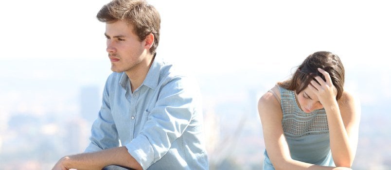 White man and woman sitting worried