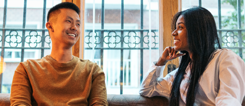 Young Adults Enjoying Conversation Indoors During Daytime