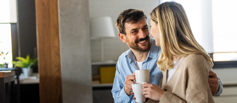 Loving Couple Sharing Drinks in Home Setting