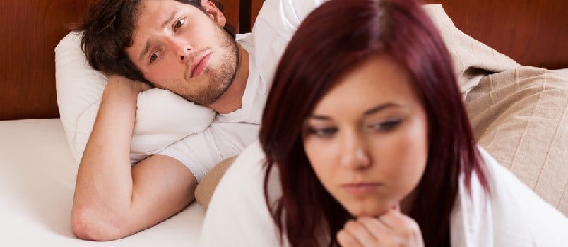 unhappy couple in bed