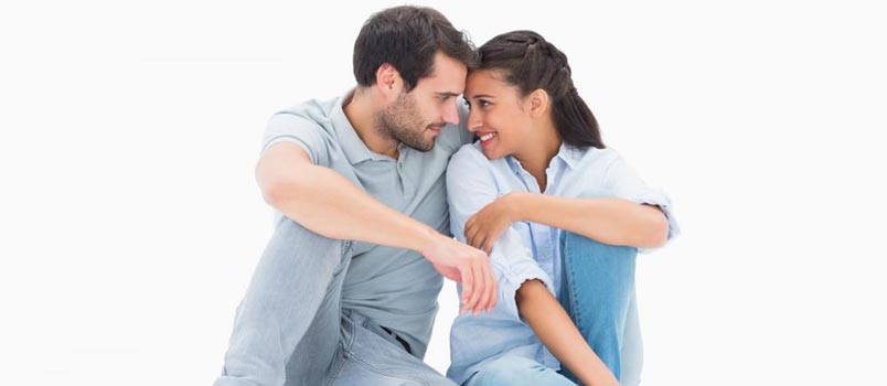 Man And Women Touching Heads Together And Smiling In White Background Studio Shot