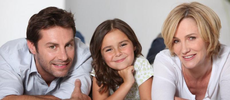 Cheerful Girl In Headphones Waving Her Hand To Friend While Communicating Through Video-chat In Front Of Laptop