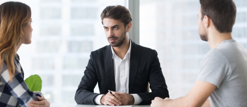 Unhappy Husband And Wife Consulting Lawyer Sitting Opposite, Young Married Couple Split Up Getting Divorced Concept