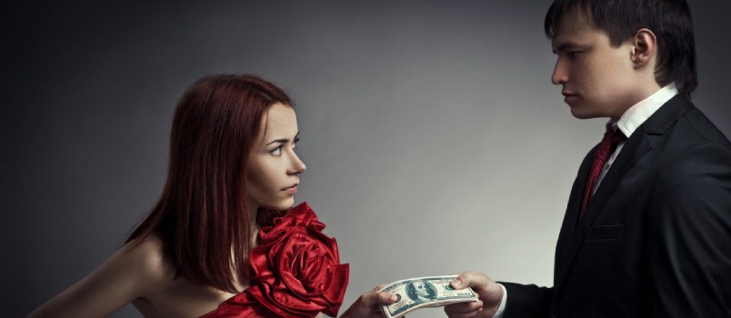 man and woman holding money