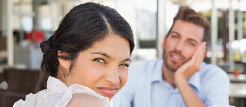 Women Ignoring, While Blurred Man Staring & Sitting In Front Of Women On Table Outdoor