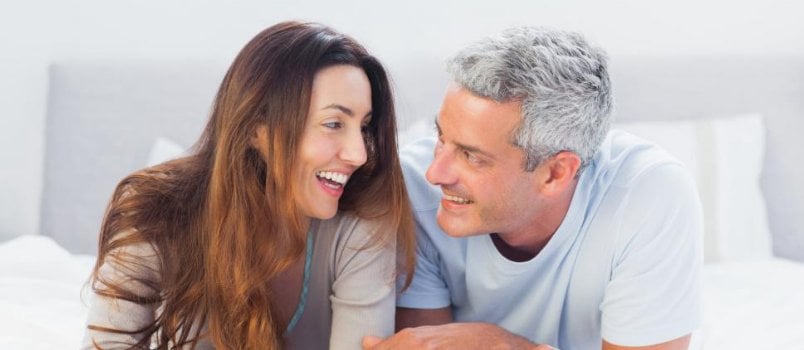 Senior Couple Smiling And Looking Each Other On Bed At Bedroom Loving Concept