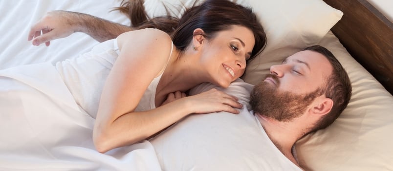 couple lying together on bed
