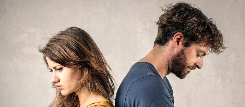 woman and man separated and sad