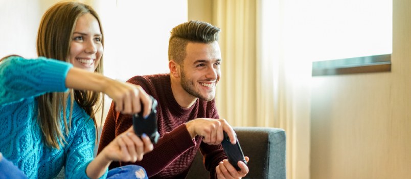 Happy couple playing video games together