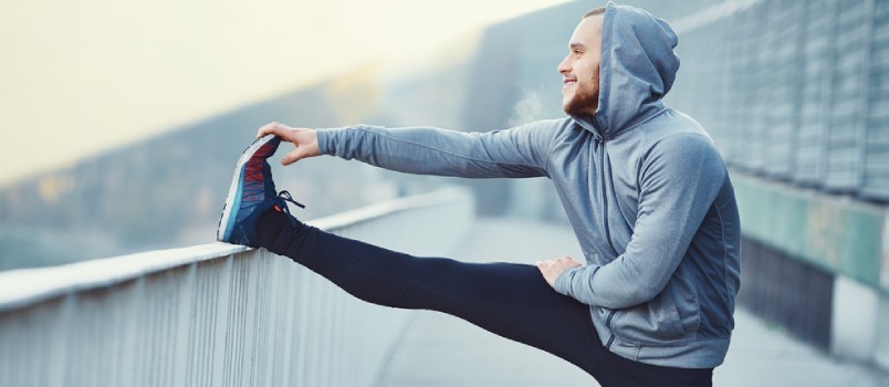 White man stretching while working out