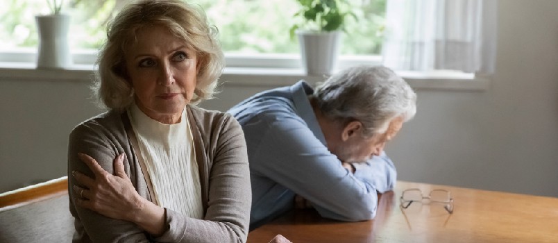 Pensive senior Caucasian woman and husband think of relationships problems,