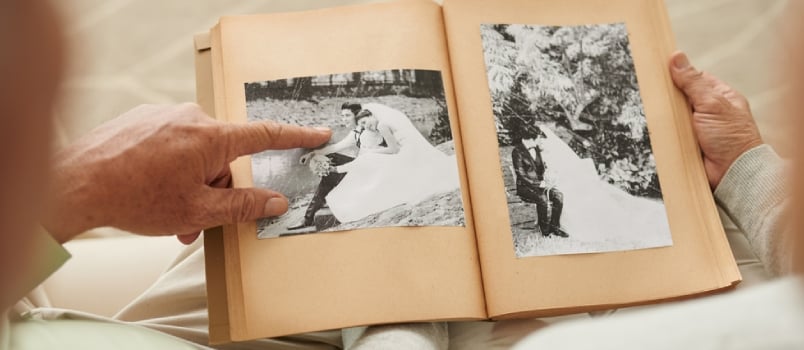 Finger pointed at black and white pictures of married couple