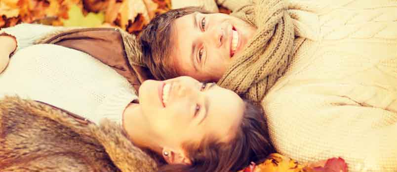 couple happily lying outdoors together