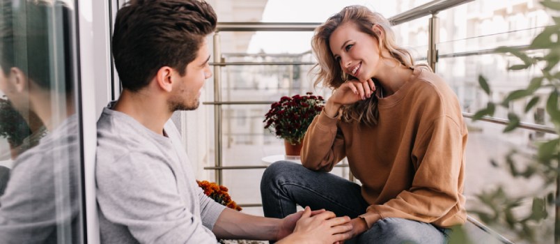 couple sitting and talking in the balcony