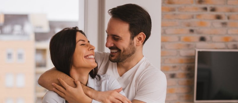 Happy man and woman looking at each other and smiling