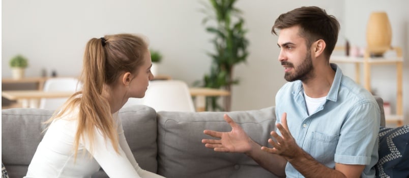 Couple having argument sitting together