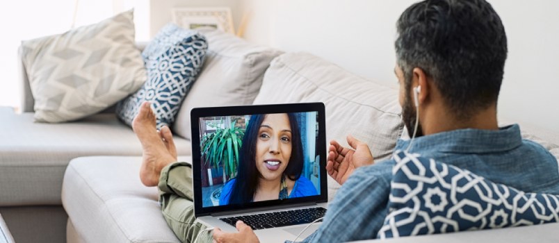 Back Top View Man Having Video Calling With A Cheerful Smiling Lady On Laptop Sitting On Sofa