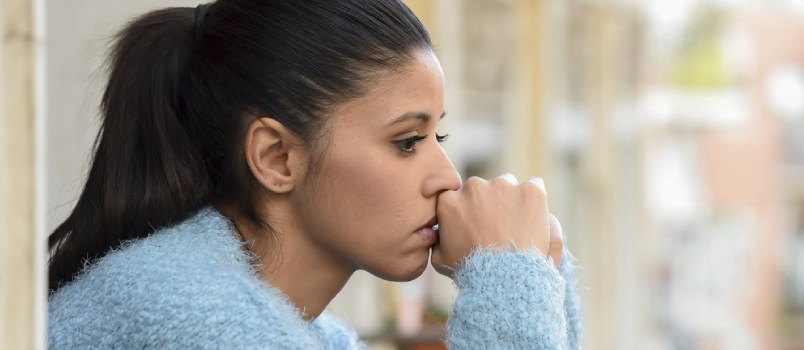 black woman sitting and thinking