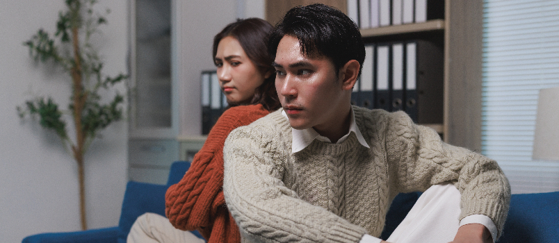 Couple Sitting Back to Back on Couch