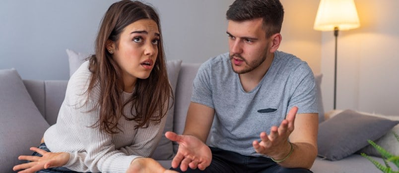 couple sitting and talking in the bedroom