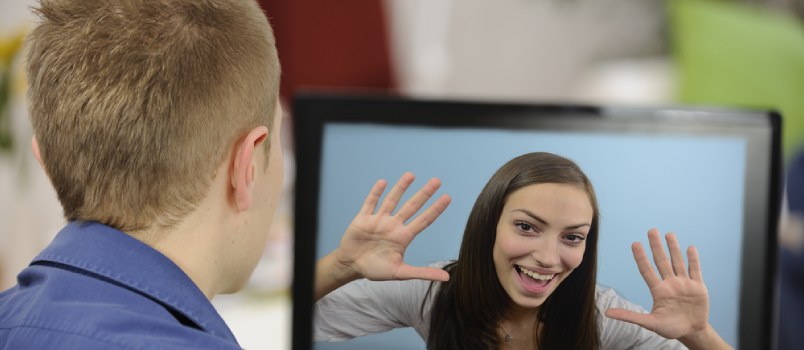 Back View Young Man Chatting Video Call With A Cheerful Lady On Laptop