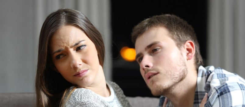 man trying to get close to woman while she is refraining