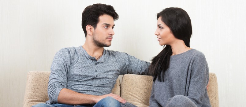 Young Happy Couple Talking Together Sitting on A Sofa