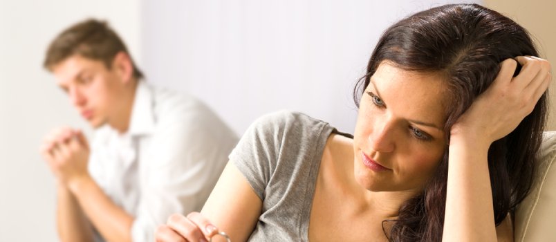 Man and woman sitting apart after having a fight