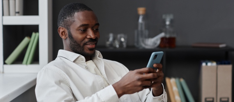 African man using smartphone