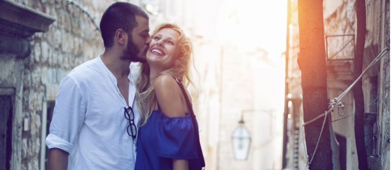 Young man kissing woman