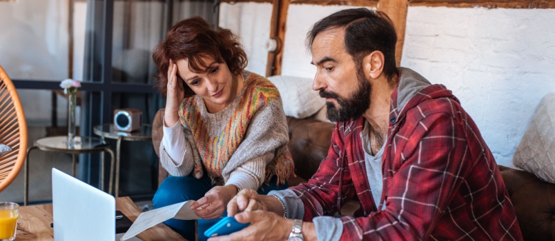 Mature couple sitting on couch