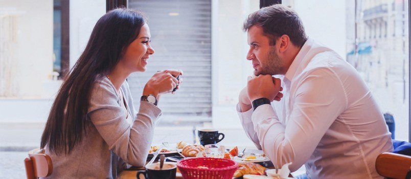 couple talking to each other across the table