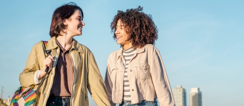 Lesbian couple laughing while walking