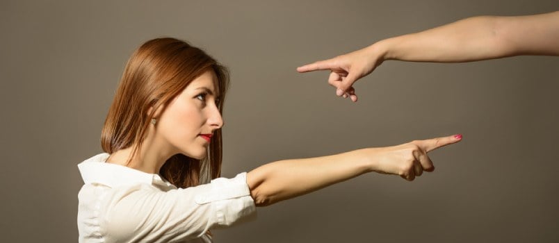 Couple pointing fingers at each other