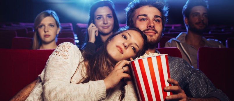 Young Boyfriend And Girlfriend Watching Movie On Theater