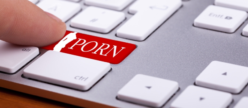 finger pressing on red button with porn word and naked woman silhouette on it